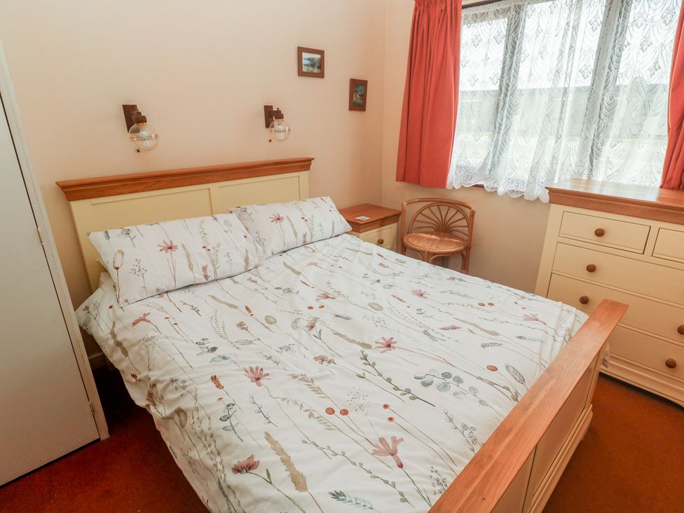 A bedroom with a bed and nightstand at 14 Bosvigo Ruan Major near Penhale