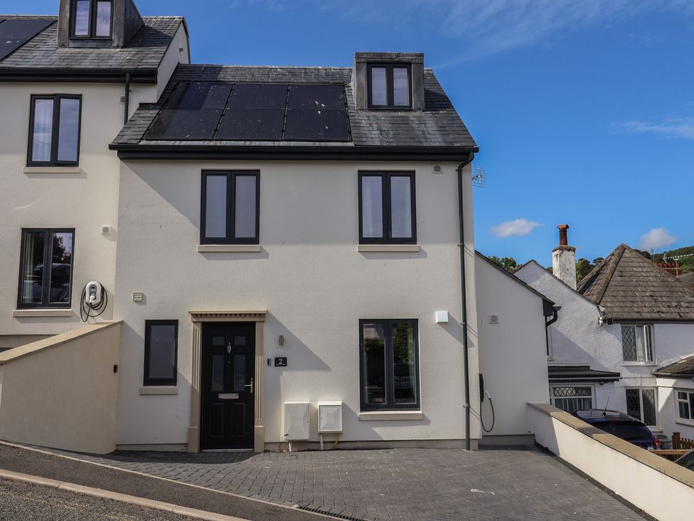 A house with solar panels and a driveway at Wagtail Cottage in Lyme Regis