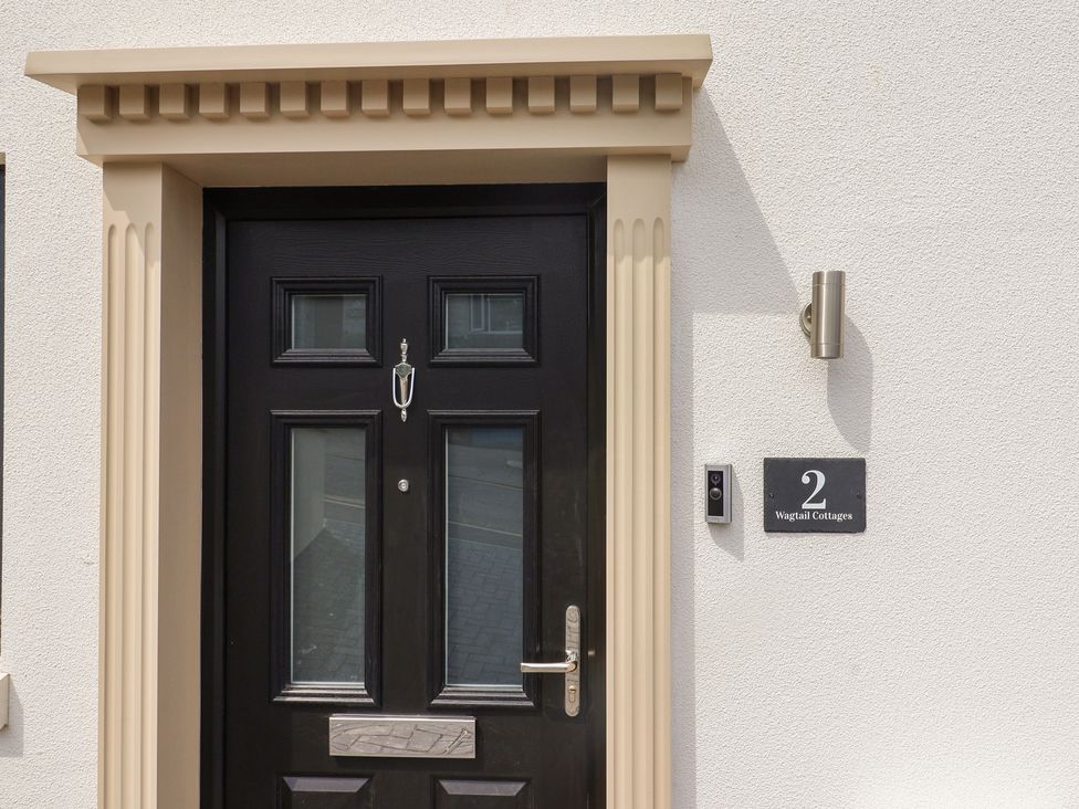 A front door with a nameplate and doorbell at Wagtail Cottage Lyme Regis