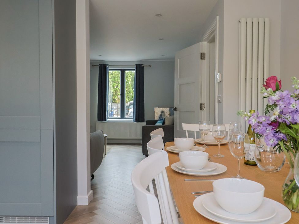 A kitchen with a dining table set for a meal at Wagtail Cottage in Lyme Regis