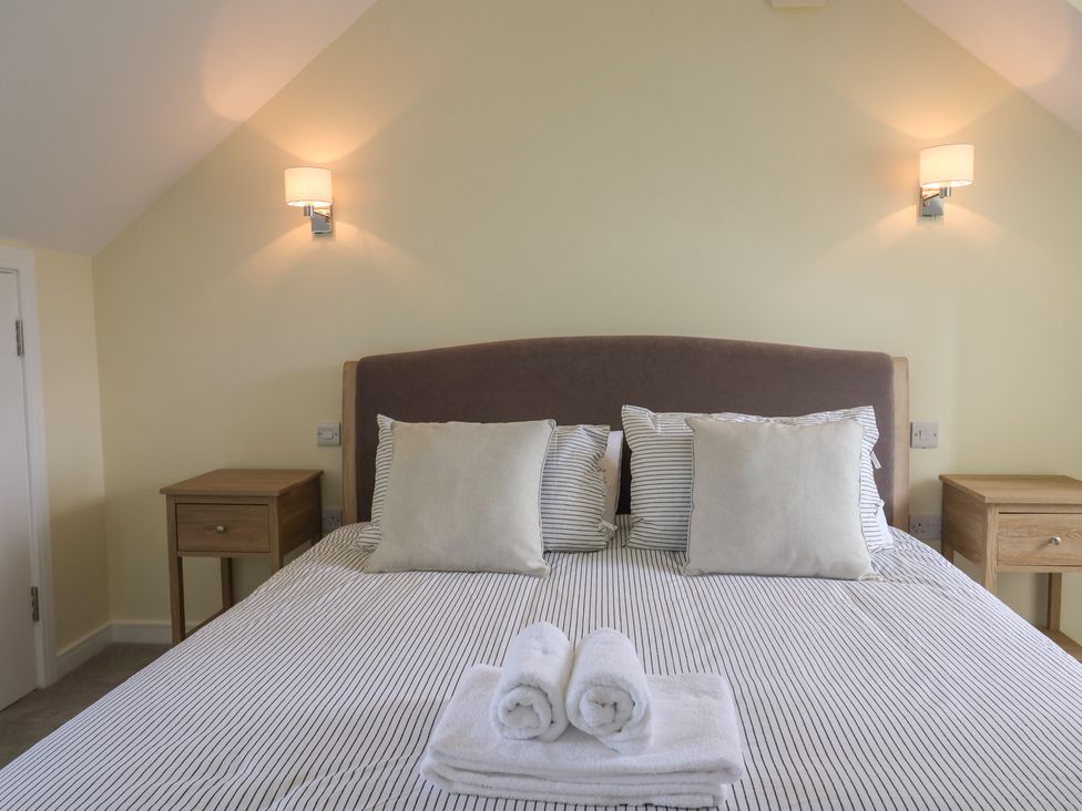 A bedroom with a bed and bedside tables at Wagtail Cottage in Lyme Regis