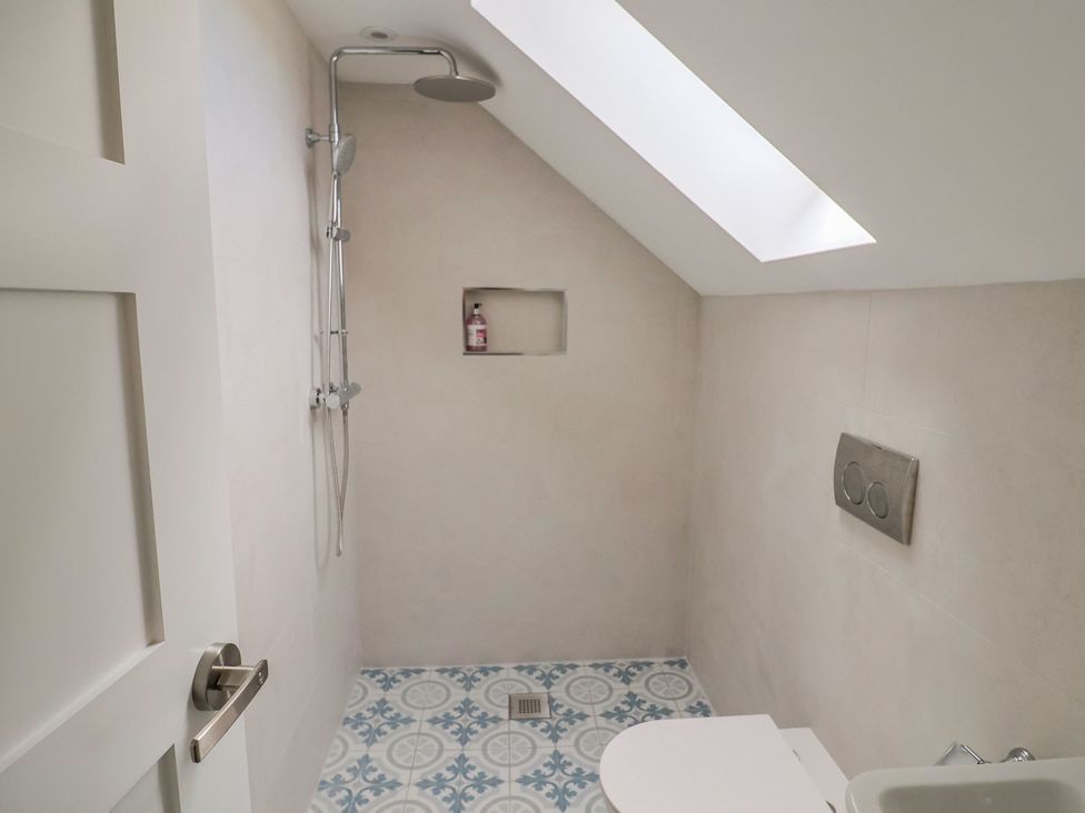 A bathroom with a shower and toilet at Wagtail Cottage in Lyme Regis