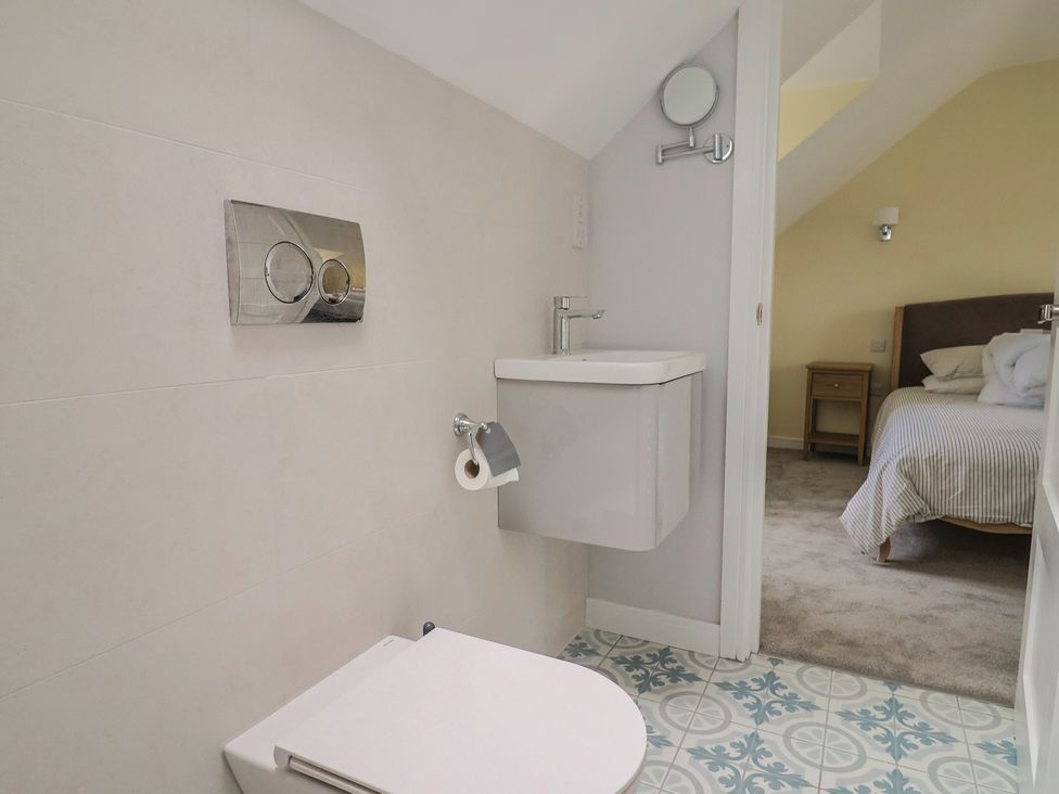 A bathroom with a toilet and sink at Wagtail Cottage in Lyme Regis