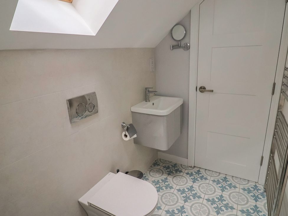 A bathroom with a toilet and sink at Wagtail Cottage in Lyme Regis