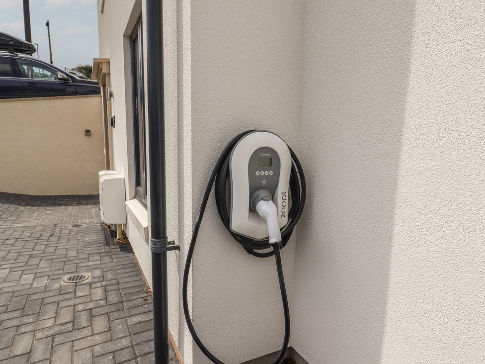 An electric vehicle charger mounted on a wall at Wagtail Cottage in Lyme Regis