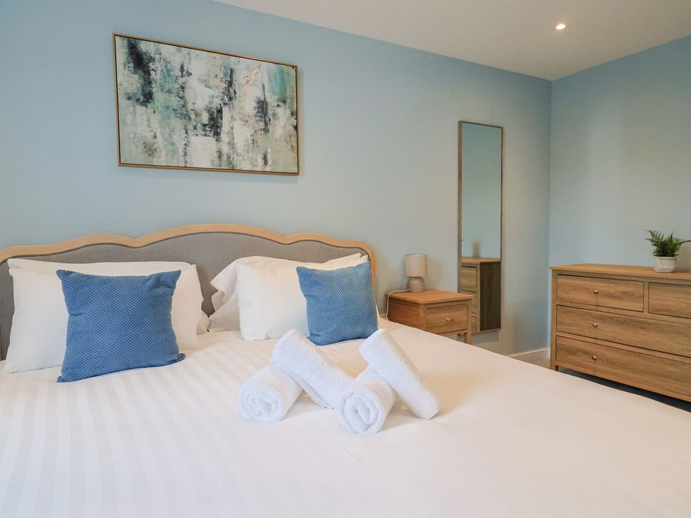 A bedroom with a bed and chest of drawers at Wagtail Cottage in Lyme Regis