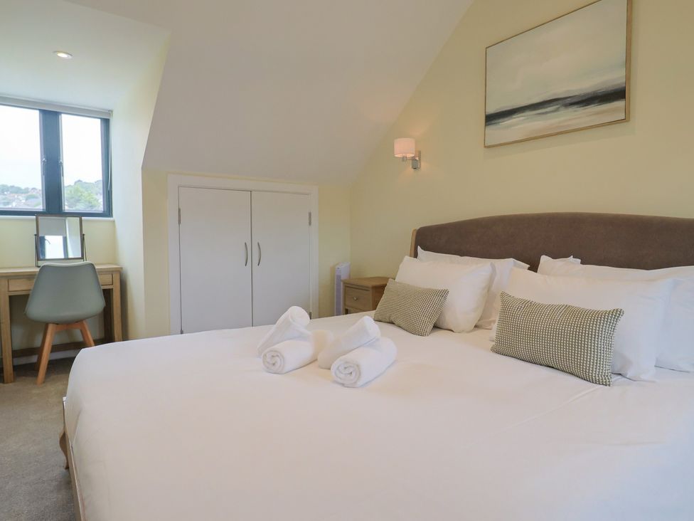 A bedroom with a bed and desk at Wagtail Cottage in Lyme Regis