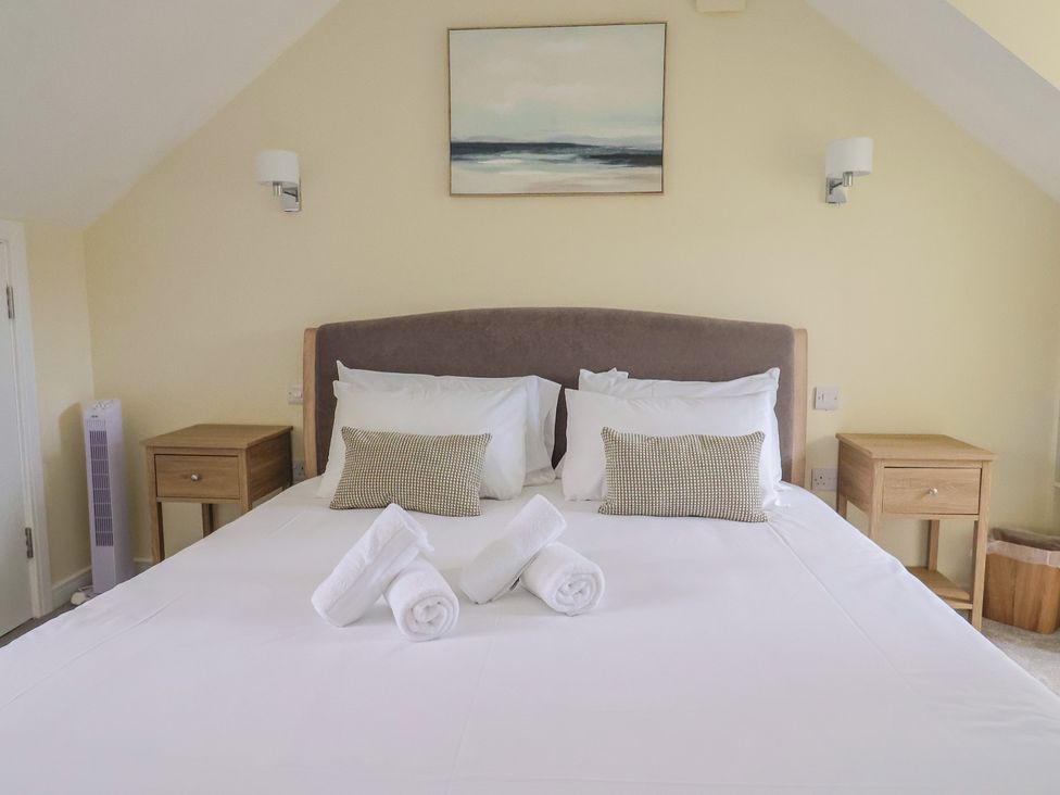 A bedroom with a bed and bedside tables at Wagtail Cottage in Lyme Regis
