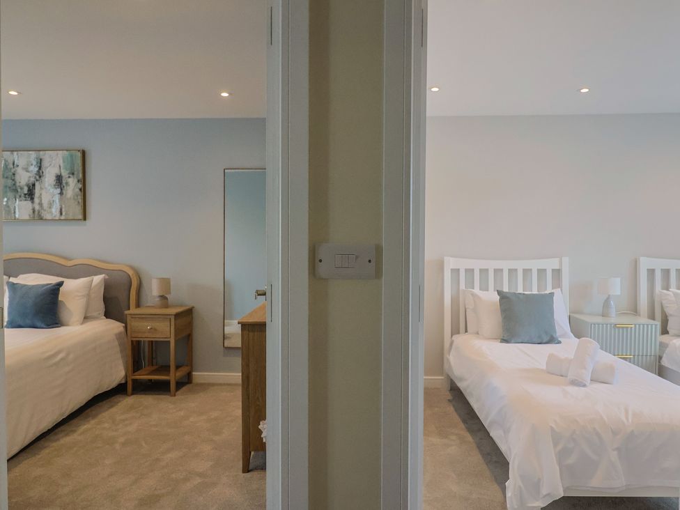 A bedroom with a bed and bedside table at Wagtail Cottage in Lyme Regis