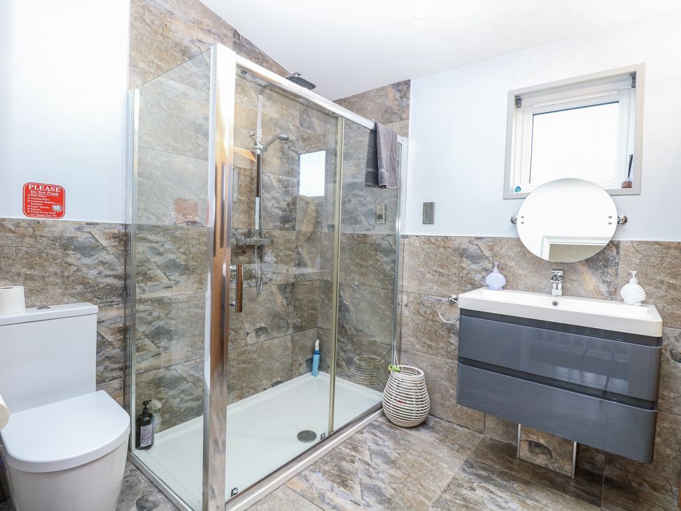 A bathroom with a shower and toilet at Angel Lodge - No 27 near Bury St Edmunds