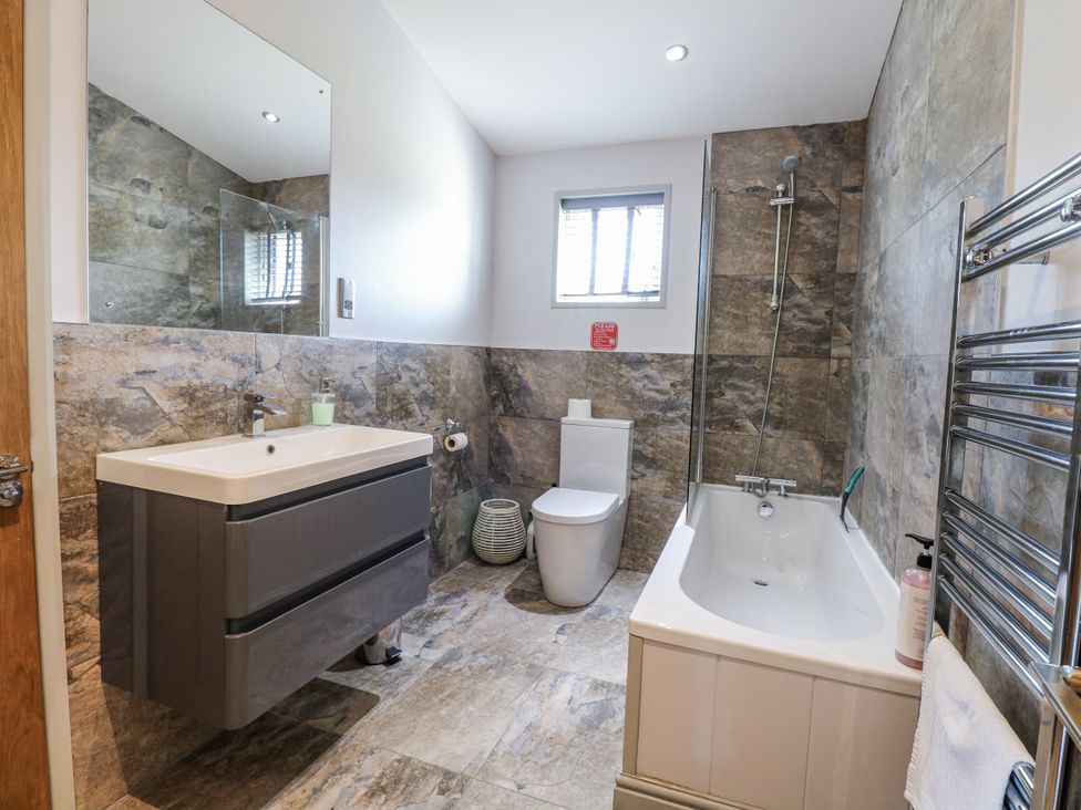 A bathroom with a sink, toilet, and shower at Angel Lodge - No 27 near Bury St Edmunds