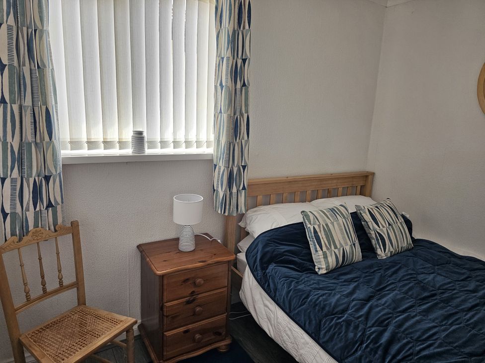 A bedroom with a bed and a chair at Seahorses
