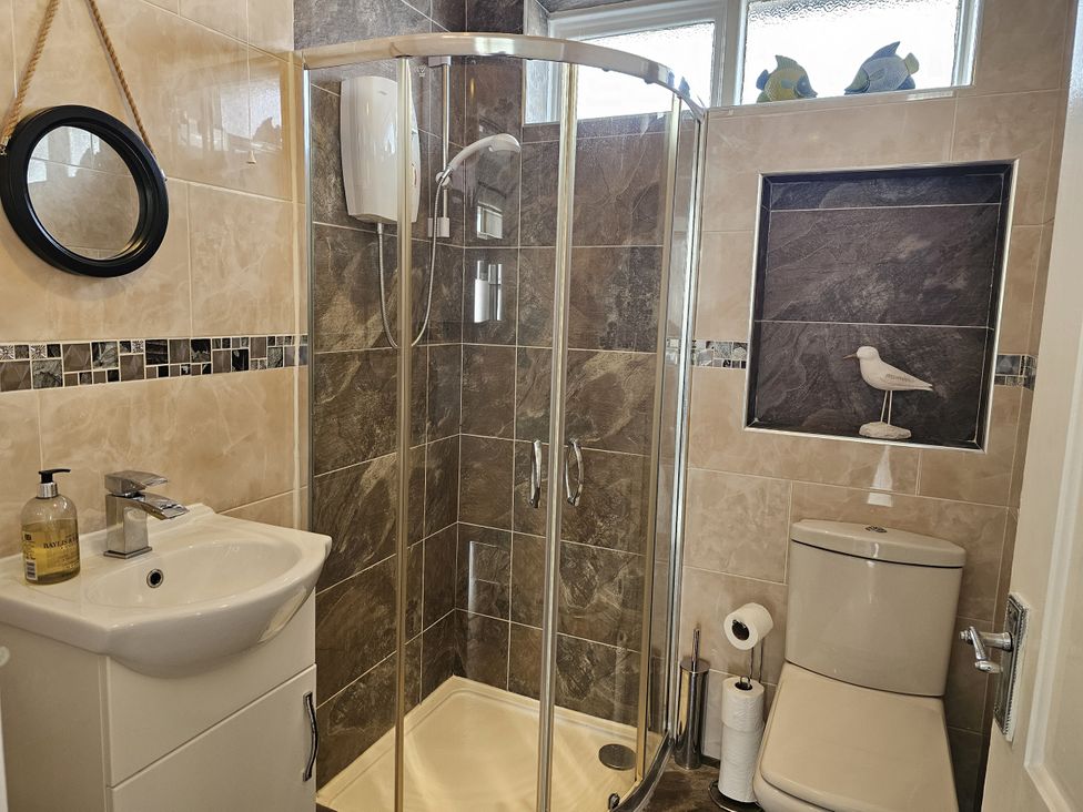 A bathroom with a shower and sink at Seahorses