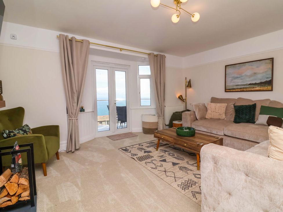 A living room with a sofa and coffee table at Combe View in Ilfracombe