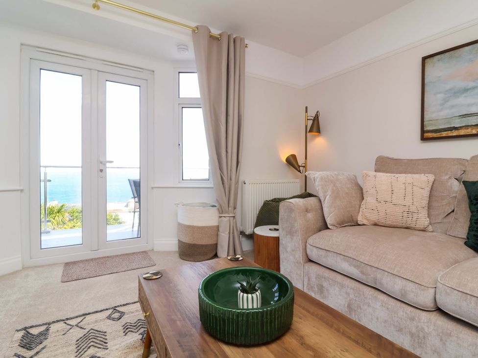 A living room with a sofa and coffee table at Combe View in Ilfracombe