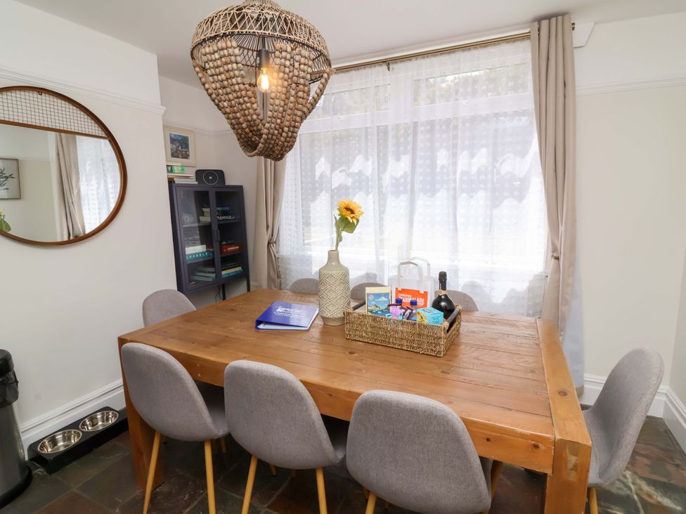 A dining room with a table and chairs at Combe View in Ilfracombe