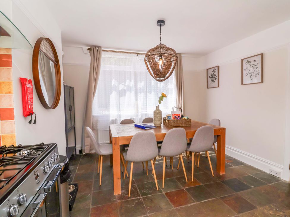 A dining room with a table and chairs at Combe View Ilfracombe