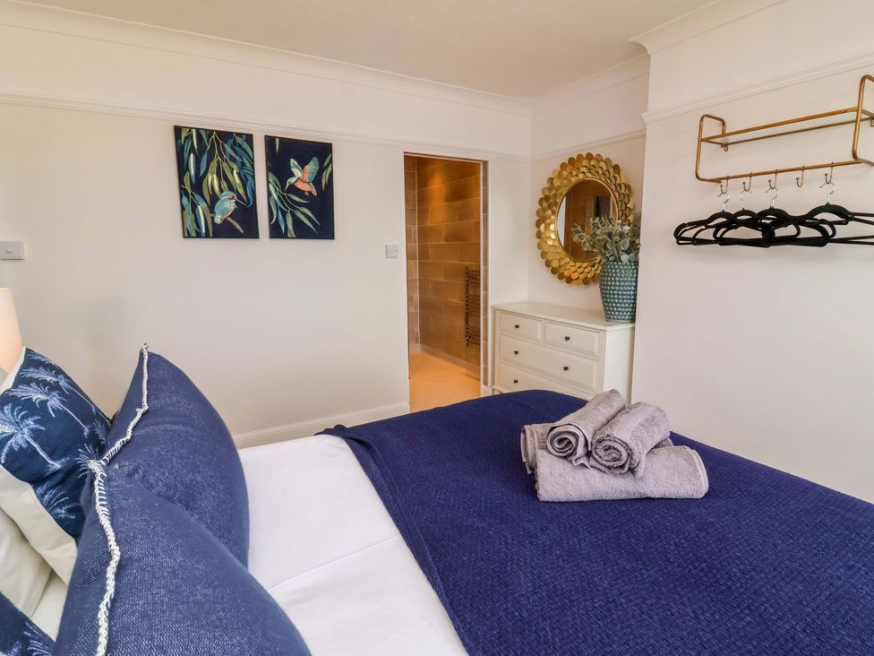 A bedroom with a bed and towels on it at Combe View in Ilfracombe
