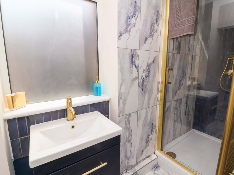 A bathroom with a sink and shower at Combe View Ilfracombe