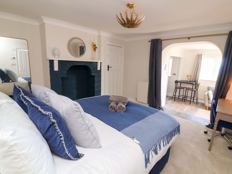 A bedroom featuring a bed and a desk at Combe View Ilfracombe