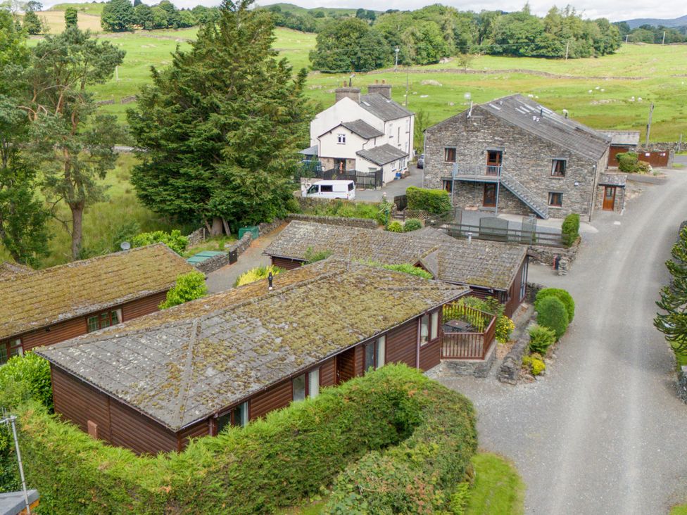 An outdoor view of several houses and greenery at Lodge 3 At Pound Farm in Crook near Kendal