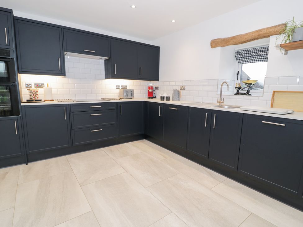 A kitchen with cabinets and appliances at Y Stabl in Cerrigydrudion