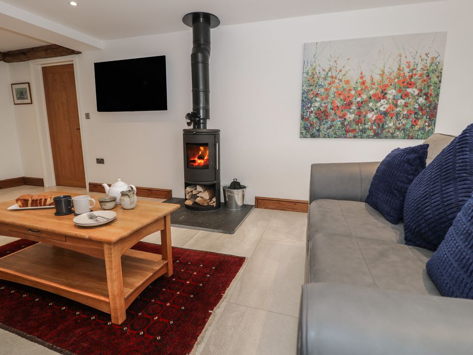 A living room with a sofa and coffee table at Y Côr in Cerrigydrudion