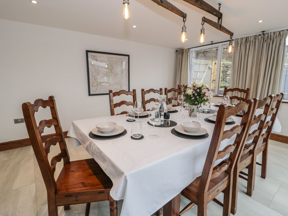 A dining room with a table set for dinner at Y Côr in Cerrigydrudion