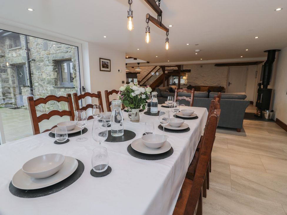 A dining room with a table set for meals at Y Côr in Cerrigydrudion