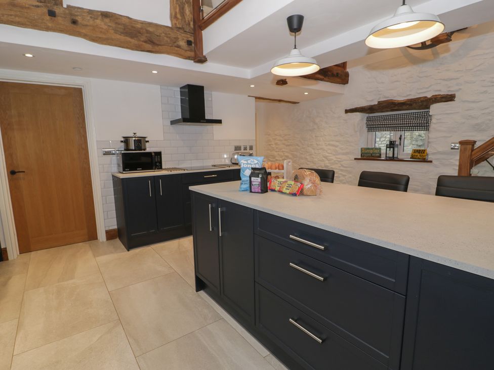 A kitchen with an island and various appliances at Y Côr in Cerrigydrudion