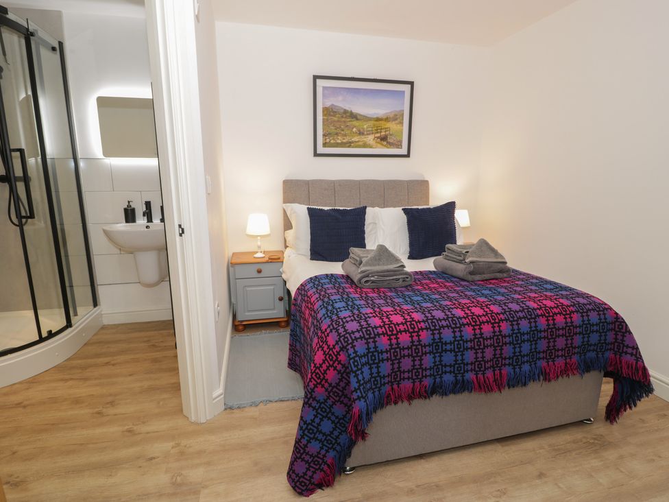 A bedroom with a bed and attached bathroom at Y Côr in Cerrigydrudion