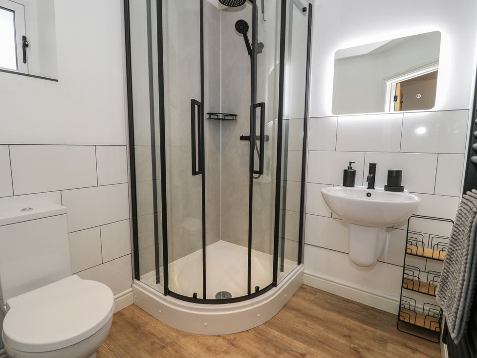 A bathroom with shower, toilet, and sink at Y Côr, Cerrigydrudion
