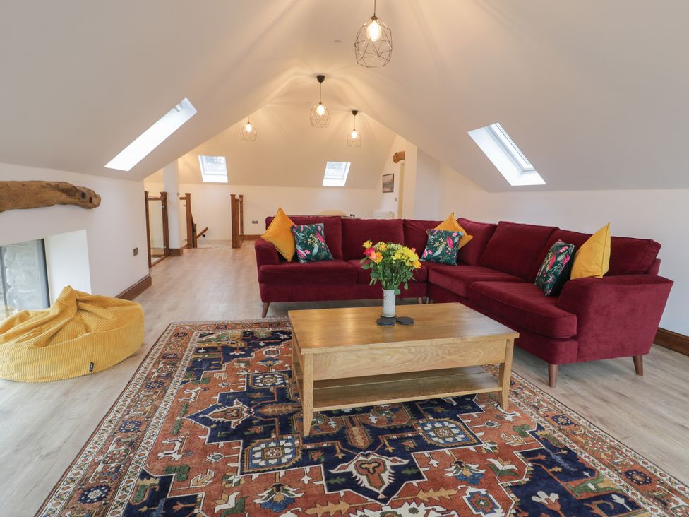 A living room with a sofa and coffee table at Y Côr in Cerrigydrudion