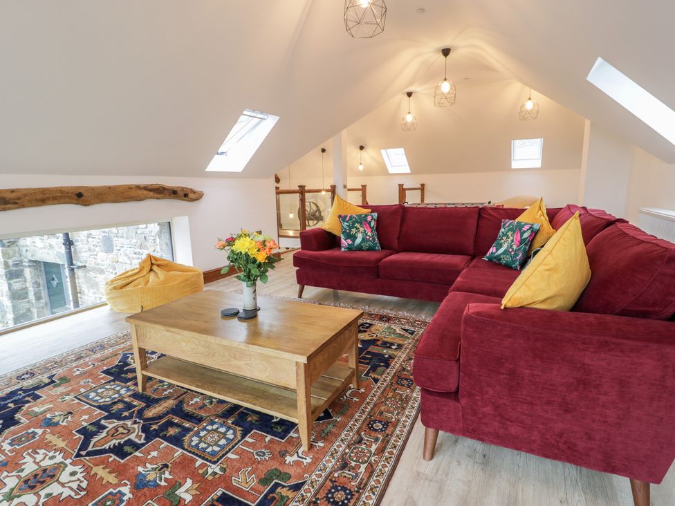 A living room with a sofa and coffee table at Y Côr in Cerrigydrudion