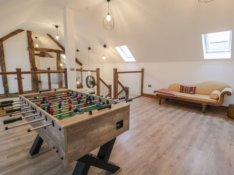 A game room with a foosball table and a couch at Y Côr in Cerrigydrudion
