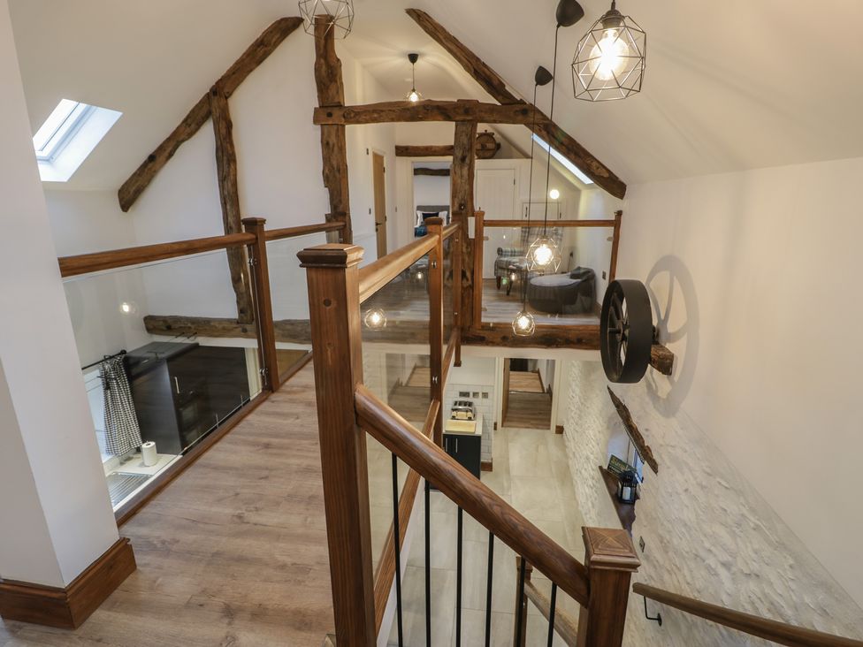 A hallway with wooden features and light fixtures at Y Côr in Cerrigydrudion
