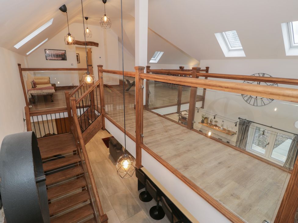 A landing with wooden railing and stairs at Y Côr in Cerrigydrudion