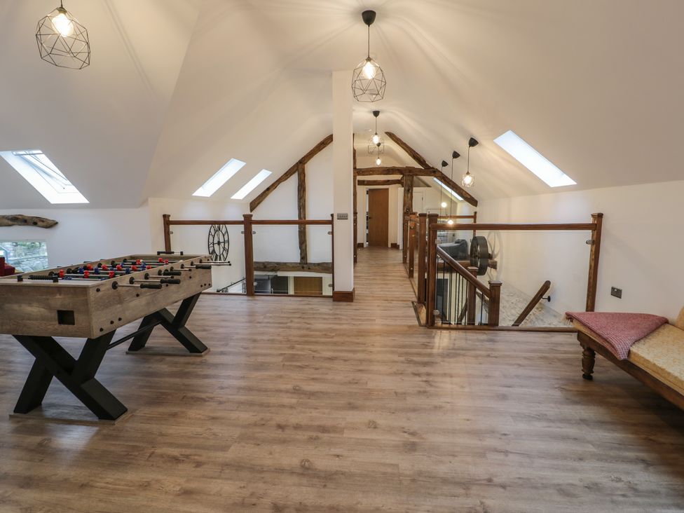 A loft area with a foosball table and skylights at Y Côr in Cerrigydrudion