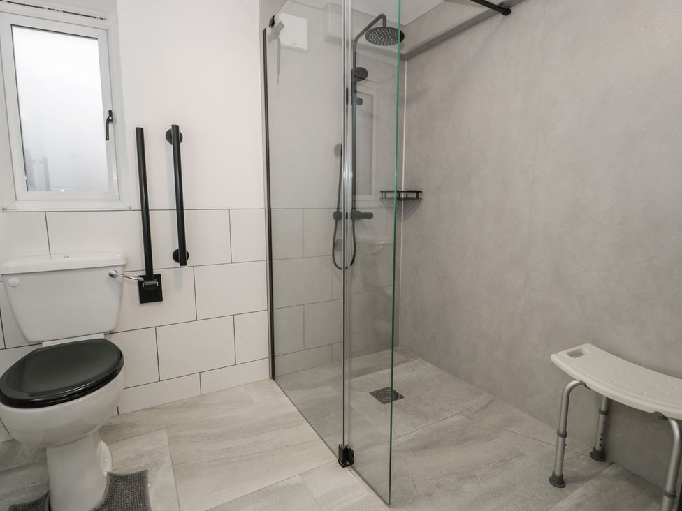 A bathroom with a shower and toilet at Y Côr in Cerrigydrudion