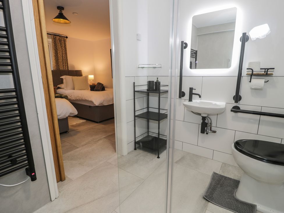 A bathroom with a shower and a hand basin at Y Côr in Cerrigydrudion