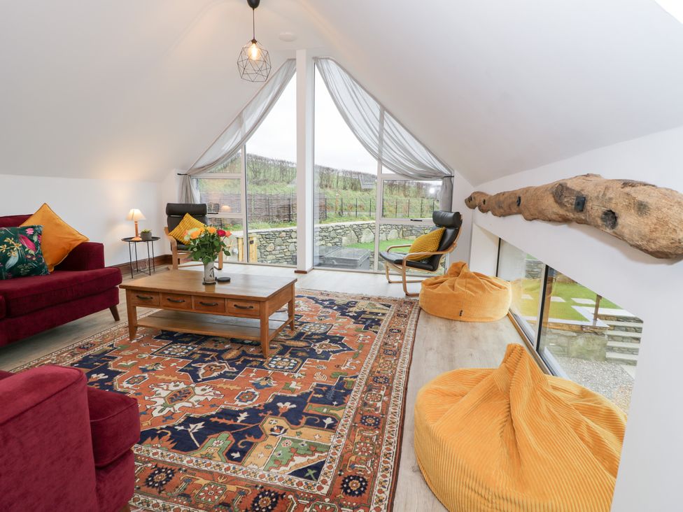 A living room with a sofa and coffee table at Y Côr in Cerrigydrudion