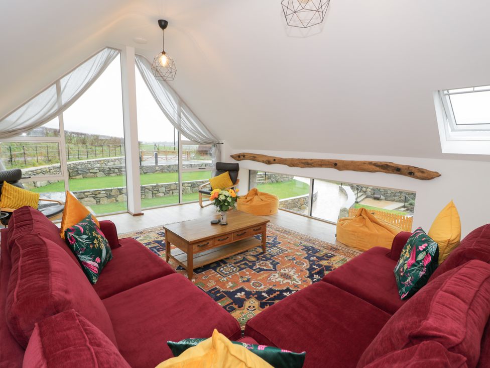 A living room with a sofa and coffee table at Y Côr in Cerrigydrudion