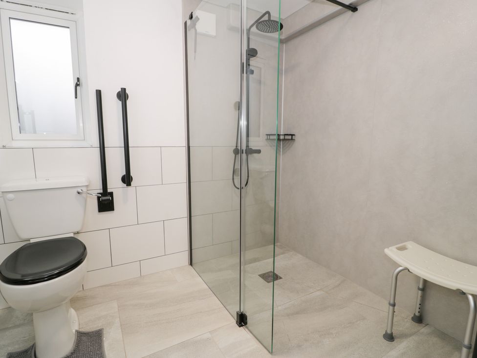 A bathroom with a shower and toilet at Y Côr in Cerrigydrudion