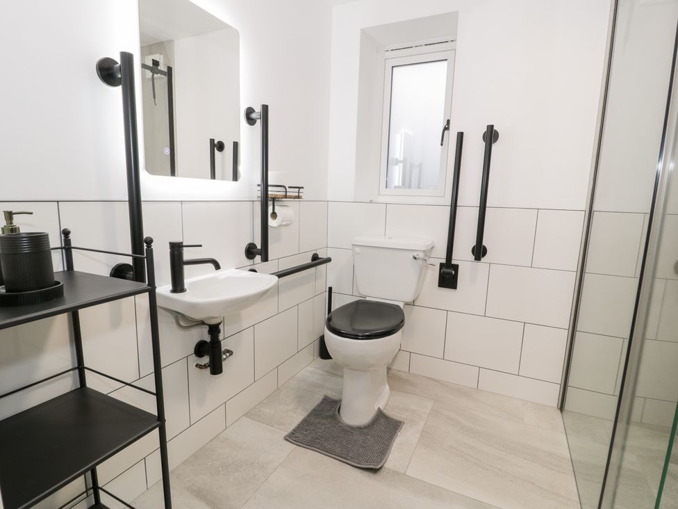 A bathroom with a toilet and sink at Y Côr in Cerrigydrudion