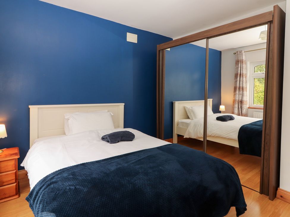 A bedroom with a bed and nightstand at Fort Lodge