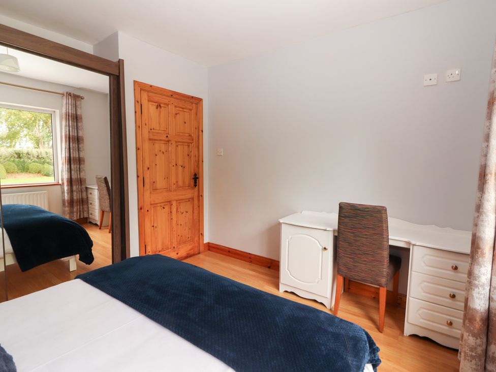 A bedroom with a bed, window, desk and chair at Fort Lodge