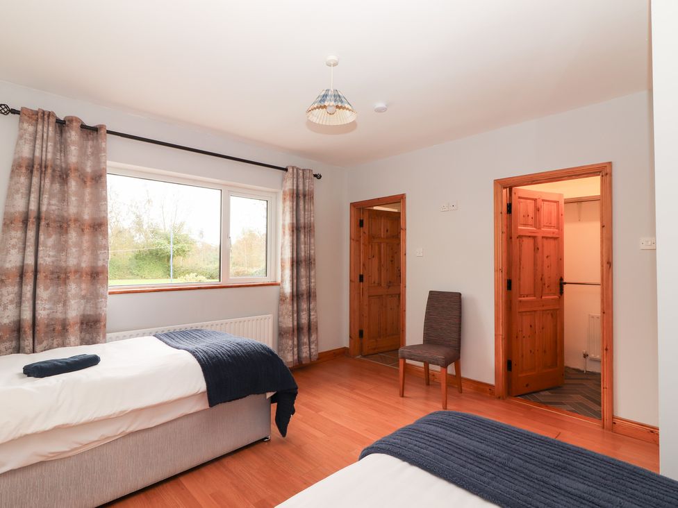 A bedroom with two beds and a window at Fort Lodge