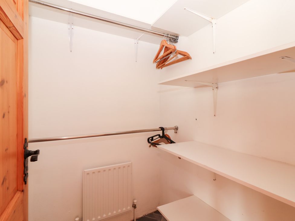 A closet with shelves and hangers at Fort Lodge
