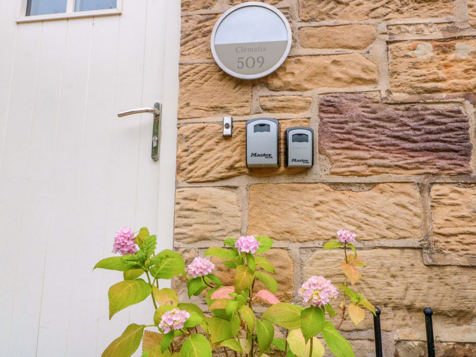 An entrance with a door and nameplate at Clematis Cottage in Whitby