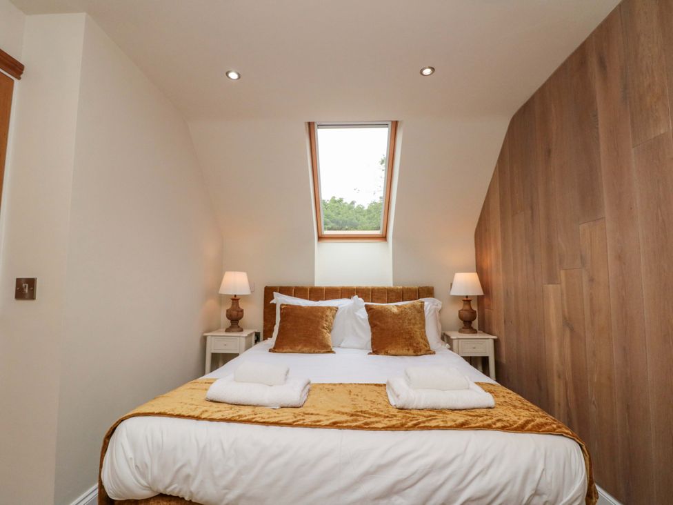 A bedroom with a bed and bedside tables at Clematis Cottage in Whitby